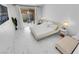 Serene bedroom boasts a sleek bed, side tables, and a view of the outdoor patio with a hammock at 9155 Bush Poppy Ave, Las Vegas, NV 89147