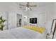 Bright bedroom features a ceiling fan, sleek TV, and neutral color scheme at 9155 Bush Poppy Ave, Las Vegas, NV 89147