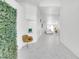 Hallway featuring modern decor, sleek chair, and a view of the open-concept living area at 9155 Bush Poppy Ave, Las Vegas, NV 89147