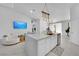 Modern kitchen featuring a large island, stainless steel appliances and a stylish lighting fixture at 9155 Bush Poppy Ave, Las Vegas, NV 89147