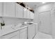 Well-lit laundry room with modern appliances, ample counter space, and convenient storage cabinets at 9155 Bush Poppy Ave, Las Vegas, NV 89147