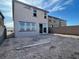 Backyard with sliding glass door, unfinished yard, and block wall at 9556 Hinson St, Las Vegas, NV 89139