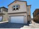 Charming two-story home featuring a large two-car garage and inviting architectural details at 9556 Hinson St, Las Vegas, NV 89139