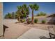 An appealing backyard featuring palm trees, desert landscaping, and a seating area perfect for relaxing at 9604 Summer Cypress St, Las Vegas, NV 89123