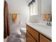 Bright bathroom showcases a vanity, sink, and shower-curtained tub at 9604 Summer Cypress St, Las Vegas, NV 89123