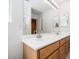 Double sink bathroom vanity with a large mirror and modern fixtures at 9604 Summer Cypress St, Las Vegas, NV 89123