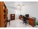 Bedroom area with natural light, fan, desk, and a wall full of shelving at 9604 Summer Cypress St, Las Vegas, NV 89123