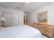 Well-lit bedroom features a large bed, wooden furniture, and closet space at 9604 Summer Cypress St, Las Vegas, NV 89123