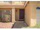 Inviting front entrance with a stylish door, manicured landscaping, and a well-lit walkway at 9604 Summer Cypress St, Las Vegas, NV 89123