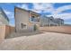 Spacious backyard featuring neutral stucco house with second-story balcony and block wall; ideal for entertaining and relaxing at 10038 W Meranto Ave, Las Vegas, NV 89178