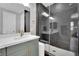 Modern bathroom with stone tile shower, white trim, contemporary vanity, and sleek door at 10038 W Meranto Ave, Las Vegas, NV 89178
