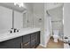 Modern bathroom featuring a sleek vanity with gold hardware and a shower-tub combination at 10038 W Meranto Ave, Las Vegas, NV 89178