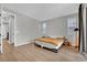Spacious bedroom featuring wood floors, multiple windows, and neutral decor at 10038 W Meranto Ave, Las Vegas, NV 89178