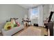 Cozy bedroom with large window, soft rug, and musical instruments at 10038 W Meranto Ave, Las Vegas, NV 89178