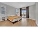 Bright bedroom featuring wood floors, a balcony, and ample natural light at 10038 W Meranto Ave, Las Vegas, NV 89178