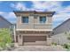 Charming two-story home featuring a paver driveway, attached two car garage and neutral exterior at 10038 W Meranto Ave, Las Vegas, NV 89178