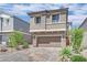 Charming two-story home featuring a paver driveway, attached two car garage and neutral exterior at 10038 W Meranto Ave, Las Vegas, NV 89178