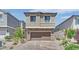 Charming two-story home featuring a paver driveway, attached two car garage and neutral exterior at 10038 W Meranto Ave, Las Vegas, NV 89178