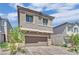 Charming two-story home featuring a paver driveway, attached two car garage and neutral exterior at 10038 W Meranto Ave, Las Vegas, NV 89178