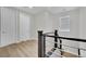 Hallway on stairway landing features wood floors, and sleek white doors at 10038 W Meranto Ave, Las Vegas, NV 89178