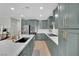 Beautiful kitchen with stainless steel appliances, quartz countertops, and modern light-green cabinetry at 10038 W Meranto Ave, Las Vegas, NV 89178