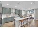 Modern kitchen with stainless steel appliances, white quartz countertops and bar stool seating at 10038 W Meranto Ave, Las Vegas, NV 89178