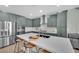 Modern kitchen features stainless steel appliances, quartz countertops, and bar stool seating at 10038 W Meranto Ave, Las Vegas, NV 89178