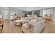 Open-concept living space with hardwood floors seamlessly connects the kitchen and living area at 10038 W Meranto Ave, Las Vegas, NV 89178