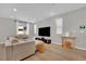 Neutral living area boasts hardwood floors, recessed lighting, and a large sectional sofa at 10038 W Meranto Ave, Las Vegas, NV 89178