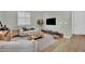 Living room with wood floors, neutral color palette, modern decor, and lots of sunlight at 10038 W Meranto Ave, Las Vegas, NV 89178