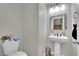 Convenient powder room with a pedestal sink, modern fixtures, and neutral decor at 10038 W Meranto Ave, Las Vegas, NV 89178