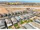 An overhead view displays similar Gathering homes surrounded by desert landscape and large hotel towers in Nevada at 10042 Bismuth St, Las Vegas, NV 89183