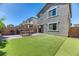 Wide backyard space with artificial turf, a grill, picnic table, and a brick perimeter at 10042 Bismuth St, Las Vegas, NV 89183