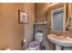 Charming powder room featuring a pedestal sink, decorative mirror, and stylish wall decor at 10042 Bismuth St, Las Vegas, NV 89183