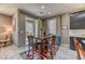 Cozy dining area with a wooden table set, stylish decor, and easy access to the patio at 10042 Bismuth St, Las Vegas, NV 89183