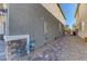 Side view of the house showing brick pavers and a gravel path at 10042 Bismuth St, Las Vegas, NV 89183