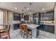 Modern kitchen with dark cabinetry, a center island, and stainless steel appliances at 10042 Bismuth St, Las Vegas, NV 89183