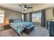 Spacious main bedroom with large windows, ceiling fan, and a comfortable upholstered bench at 10042 Bismuth St, Las Vegas, NV 89183