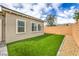 Low-maintenance backyard with artificial turf and a neutral-toned exterior at 10250 Tree Blossom Ave, Las Vegas, NV 89166