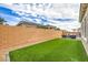 Spacious backyard with lush artificial grass and a brick wall, perfect for outdoor enjoyment at 10250 Tree Blossom Ave, Las Vegas, NV 89166