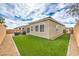 Well-maintained backyard featuring artificial grass, gravel accents, and a private patio area at 10250 Tree Blossom Ave, Las Vegas, NV 89166
