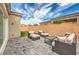 Backyard featuring a stone-paved patio, stylish furniture, a grassy area, and a secure brick wall at 10250 Tree Blossom Ave, Las Vegas, NV 89166