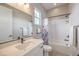 Bathroom featuring modern vanity and bath/shower combo with curtain and tile flooring at 10250 Tree Blossom Ave, Las Vegas, NV 89166