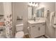 Bathroom featuring a toilet, vanity with cabinets, and a shower with a patterned curtain at 10250 Tree Blossom Ave, Las Vegas, NV 89166