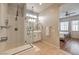 Bathroom featuring a glass-enclosed shower, white cabinets, and modern fixtures at 10250 Tree Blossom Ave, Las Vegas, NV 89166