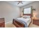 Bedroom with a ceiling fan, and a comfortable bed with side tables, and natural lighting at 10250 Tree Blossom Ave, Las Vegas, NV 89166