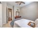 Bedroom with a ceiling fan and a comfortable bed, complete with a decorative wreath and dresser at 10250 Tree Blossom Ave, Las Vegas, NV 89166