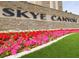Entrance sign for 'Skye Canyon' with stone backdrop and colorful flowerbeds at 10250 Tree Blossom Ave, Las Vegas, NV 89166