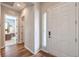 Inviting entryway featuring a white front door, wood flooring, and an open view to the bedroom at 10250 Tree Blossom Ave, Las Vegas, NV 89166