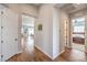 Hallway with hardwood flooring, neutral paint, and a glimpse into the living area and bedroom at 10250 Tree Blossom Ave, Las Vegas, NV 89166